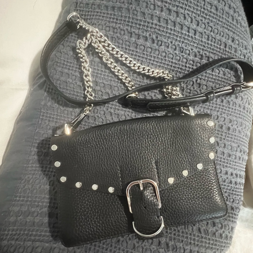 black leather Rebecca Minkoff crossbody with silver studs, buckle and chain.